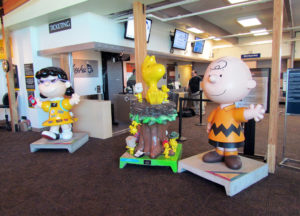 Image of the Peanuts art sculptures of Lucy, Charlie Brown and Woodstock inside the STS terminal
