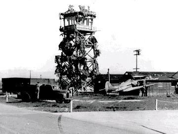 Photo of STS when it was used by the U.S. Army in 1942, showing the airport tower, camouflaged.